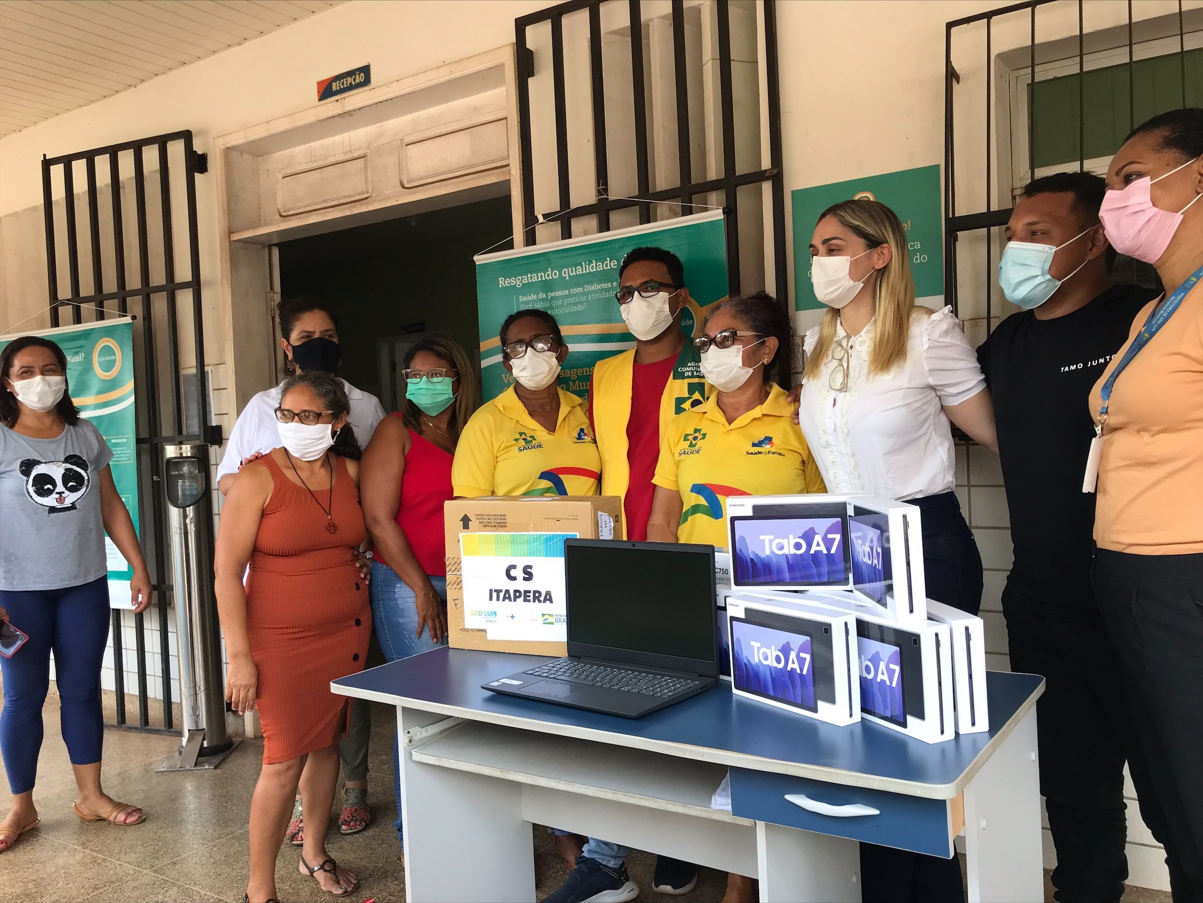 Equipe de voluntários, diretoria e beneficiados recebendo os equipamentos doados ao programa